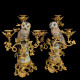 A pair of candelabras with porcelain owl and gilt-bronze vine